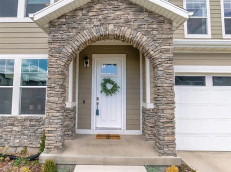 Beautiful,Facade,Of,Home,With,Arched,Stone,Entrance,And,Glass